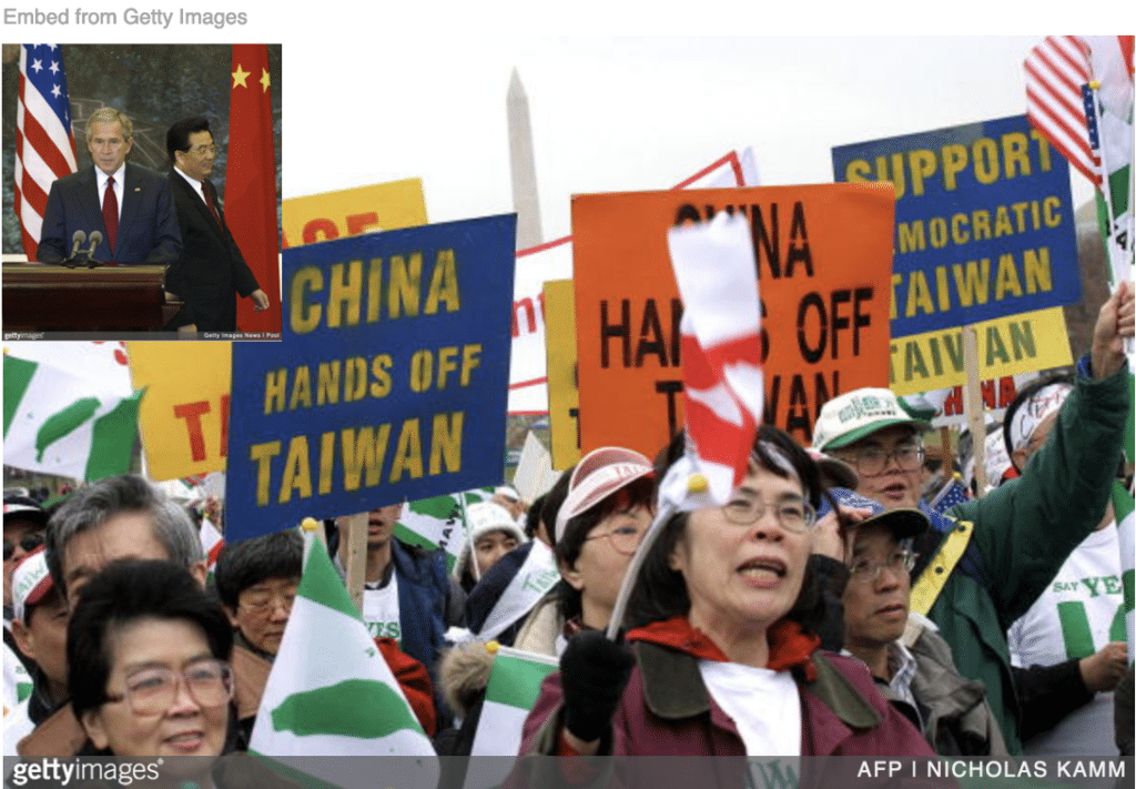 Taiwanese protesting against China with image of  George W. Bush and Hu Jintao inset.