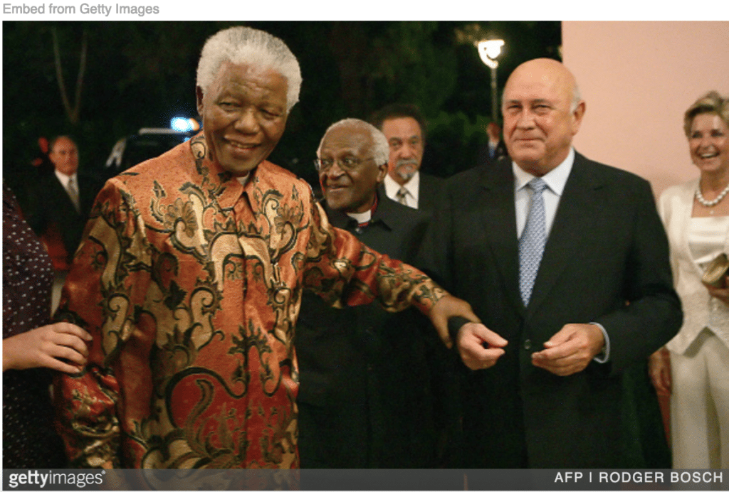 Mandela celebrating de Klerk's birthday at party. 