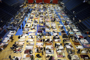 Evacuees from Serbian town of Obrenovac are seen lying on beds in a shelter hall in Belgrade