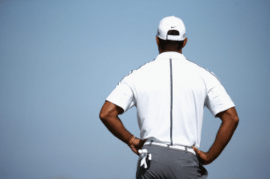 Tiger Wood back to camera as he looks on golf course