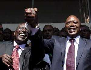 President-elect Kenyatta greets his supporters with his running mate Ruto after attending a news conference in Nairobi