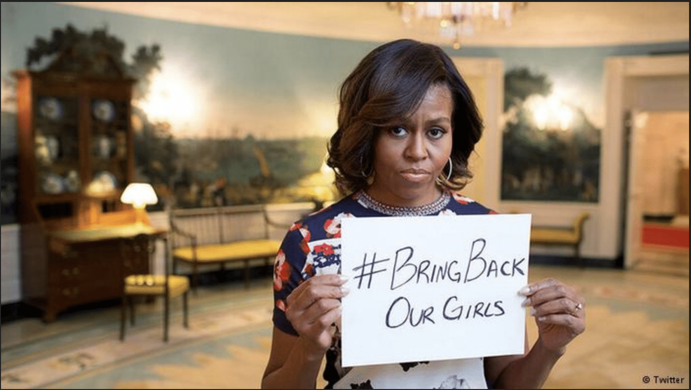 Michelle Obama holding #BringBackOurGirls placard
