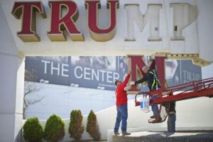 Williams, of Calvi Electric, lowers the 'M' letter from the signage of Trump Plaza Casino to his co-workers in Atlantic City, New Jersey