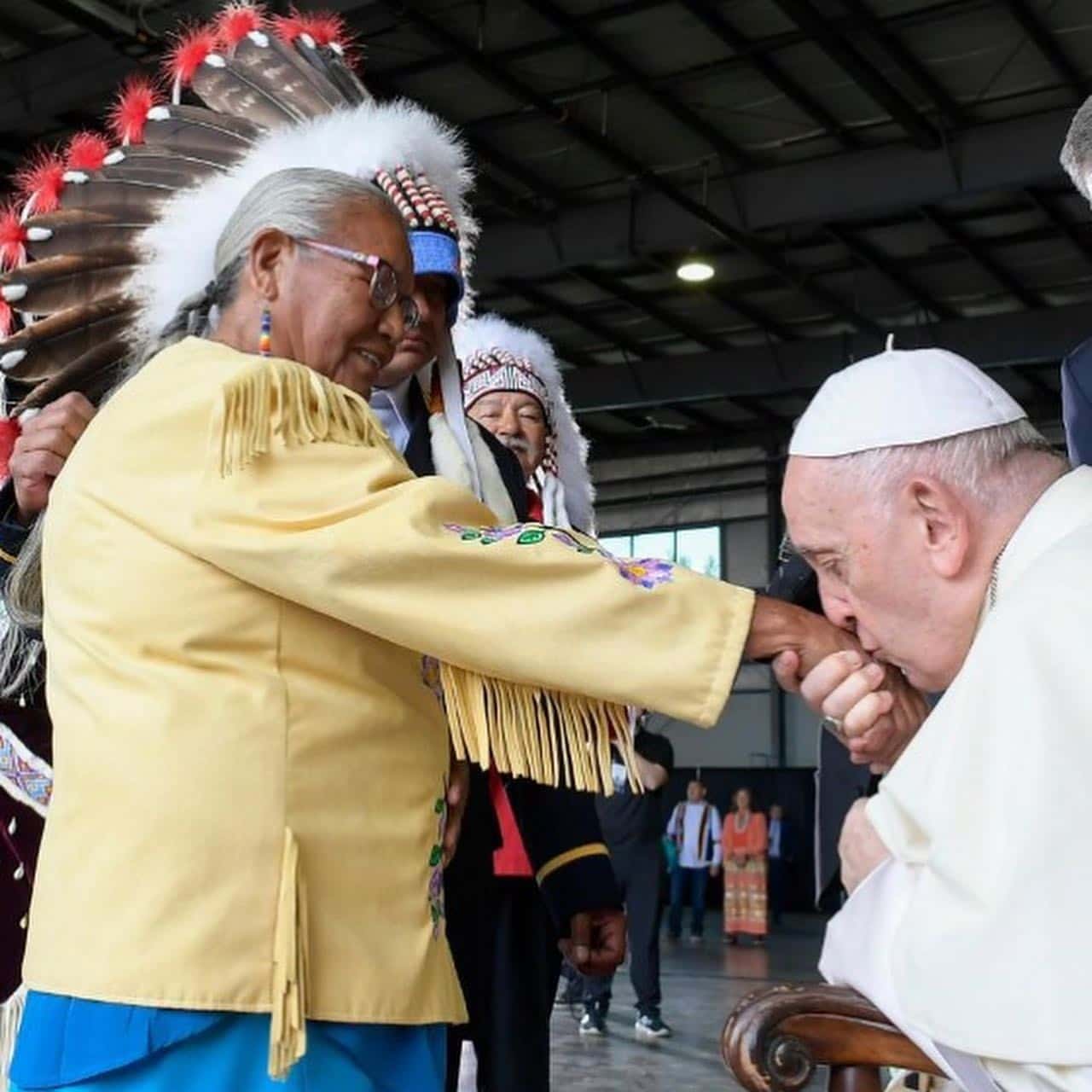 Pope Francis kissing the hand of indigenous woman on his pilgrimage of penance to Canada