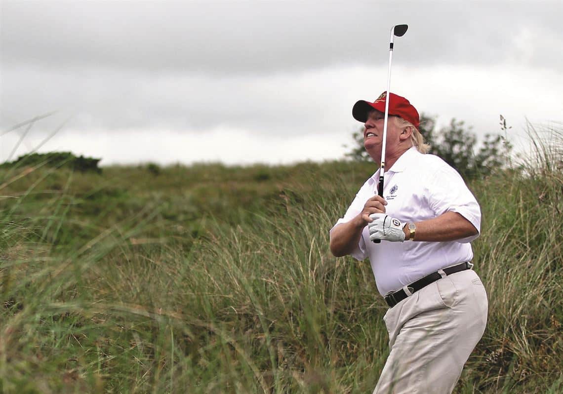 trump golfing wearing red maga red hat