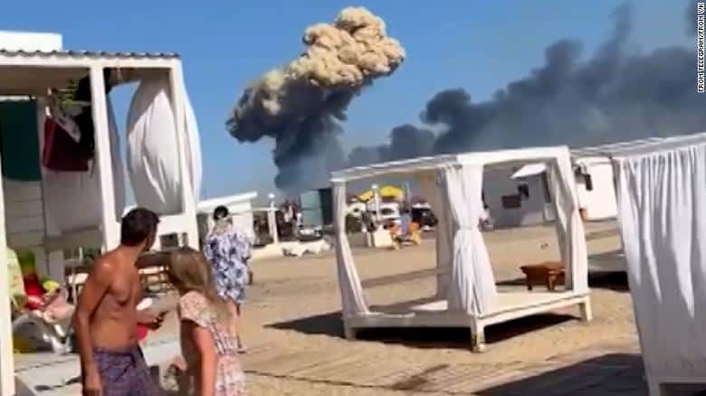 people on beach in Crimea reacting to explosion at Russian military airbase