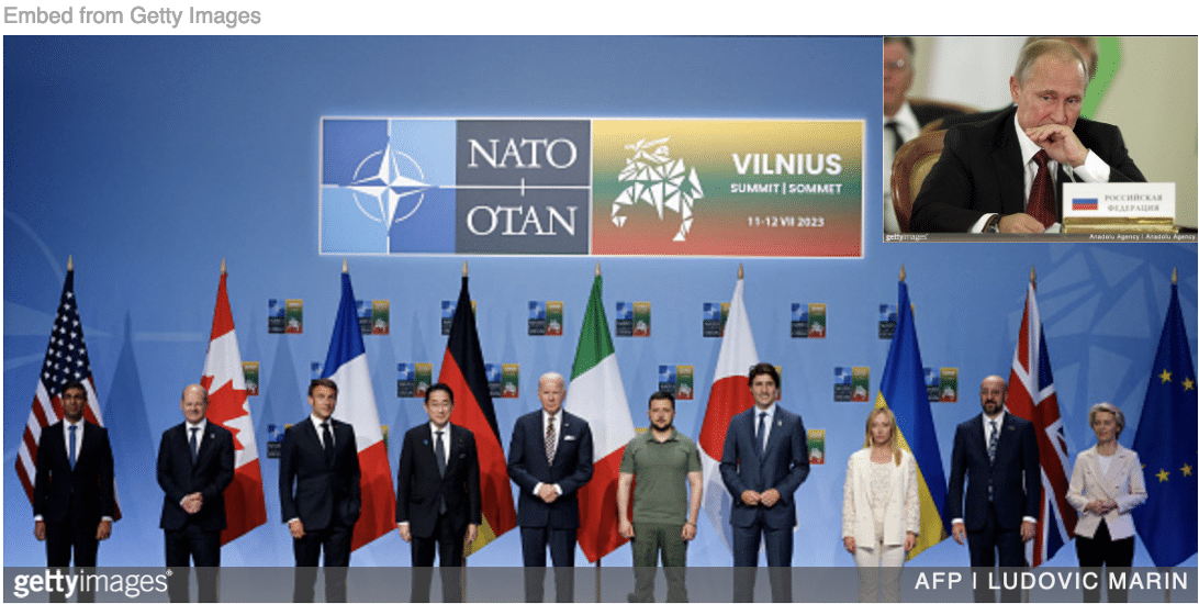 Zelensky standing front and center NATO family summit with image of Putin looking on inset.