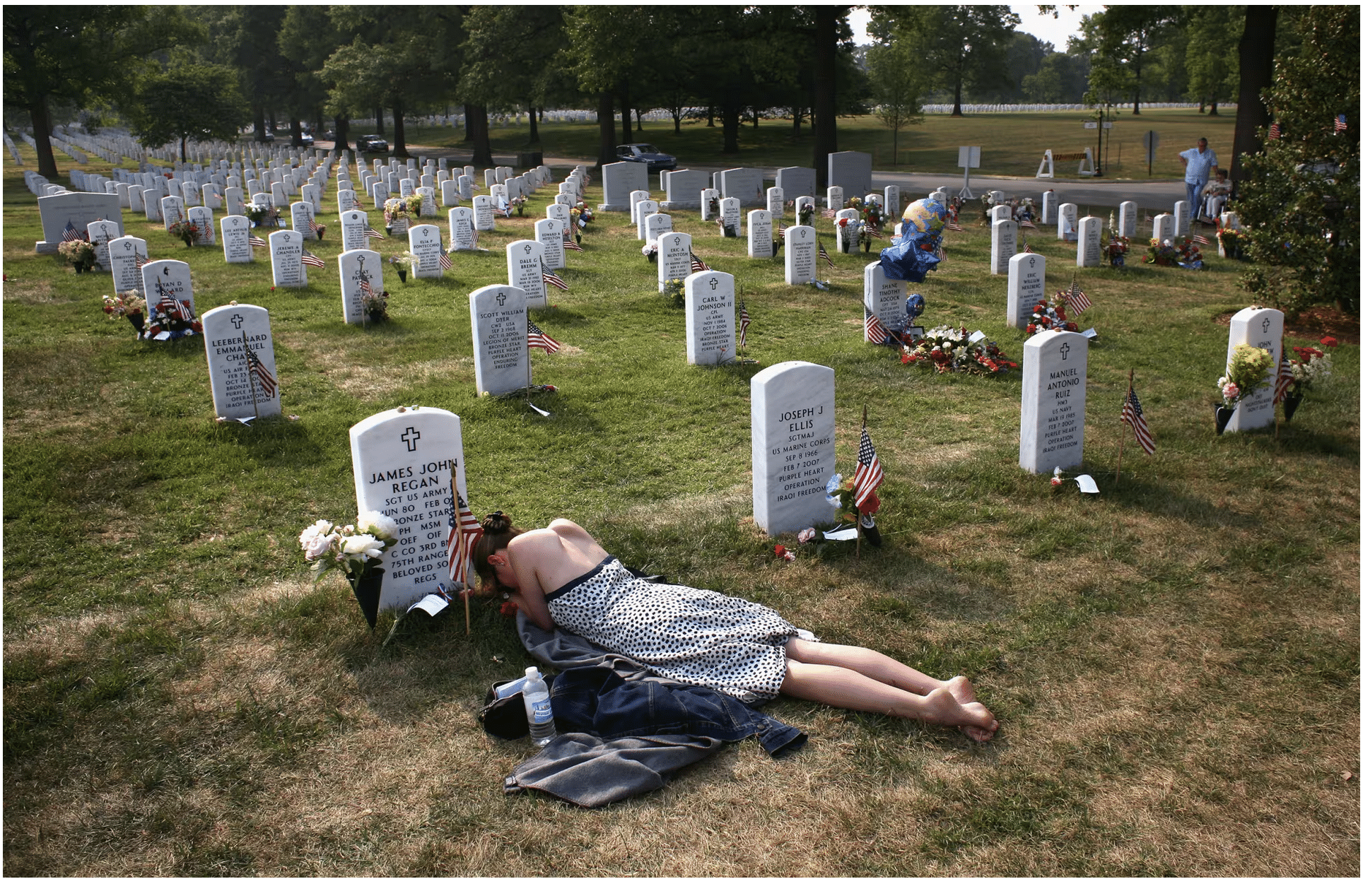 A woman grieving her loss at a military burial ground